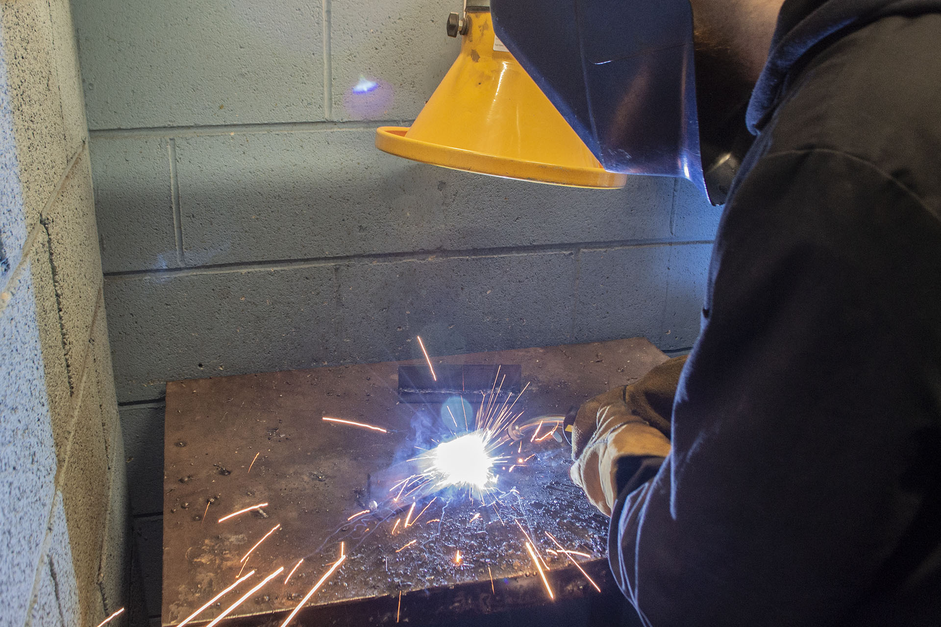 Welding. Student welding whilst wearing safety gear